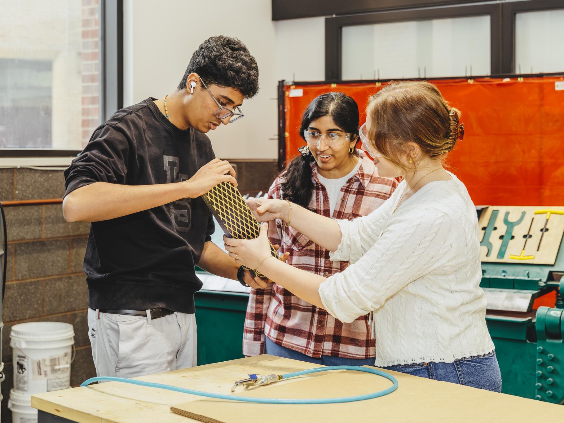 Students gather together to examine materials in an event