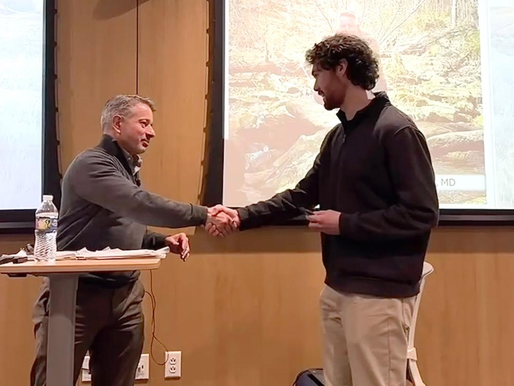 The ASHRAE president (left) presenting Penn State ASHRAE Student Branch President (right) with a memento after his presentation. Riley put together the itinerary for McQuade's visit and was his host during the visit.