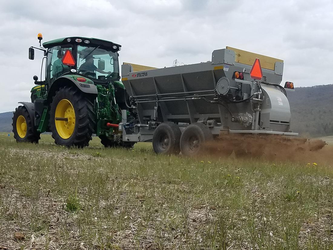 spreading chicken manure