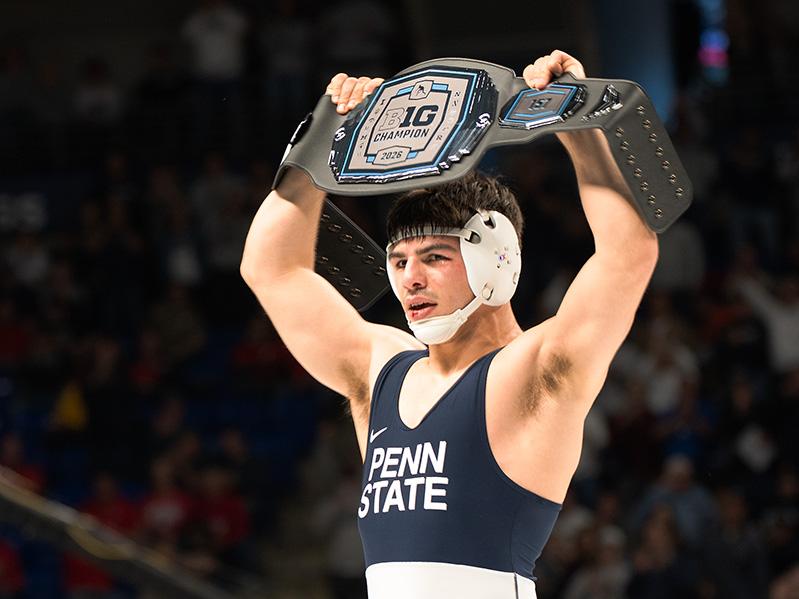 Man holding belt above his head