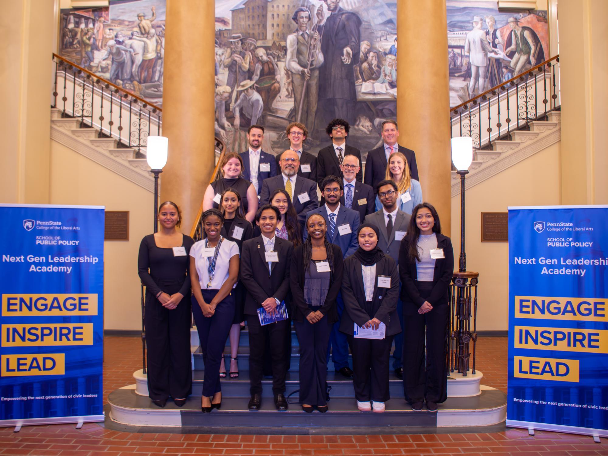 A group of students stand together inside Old Main.