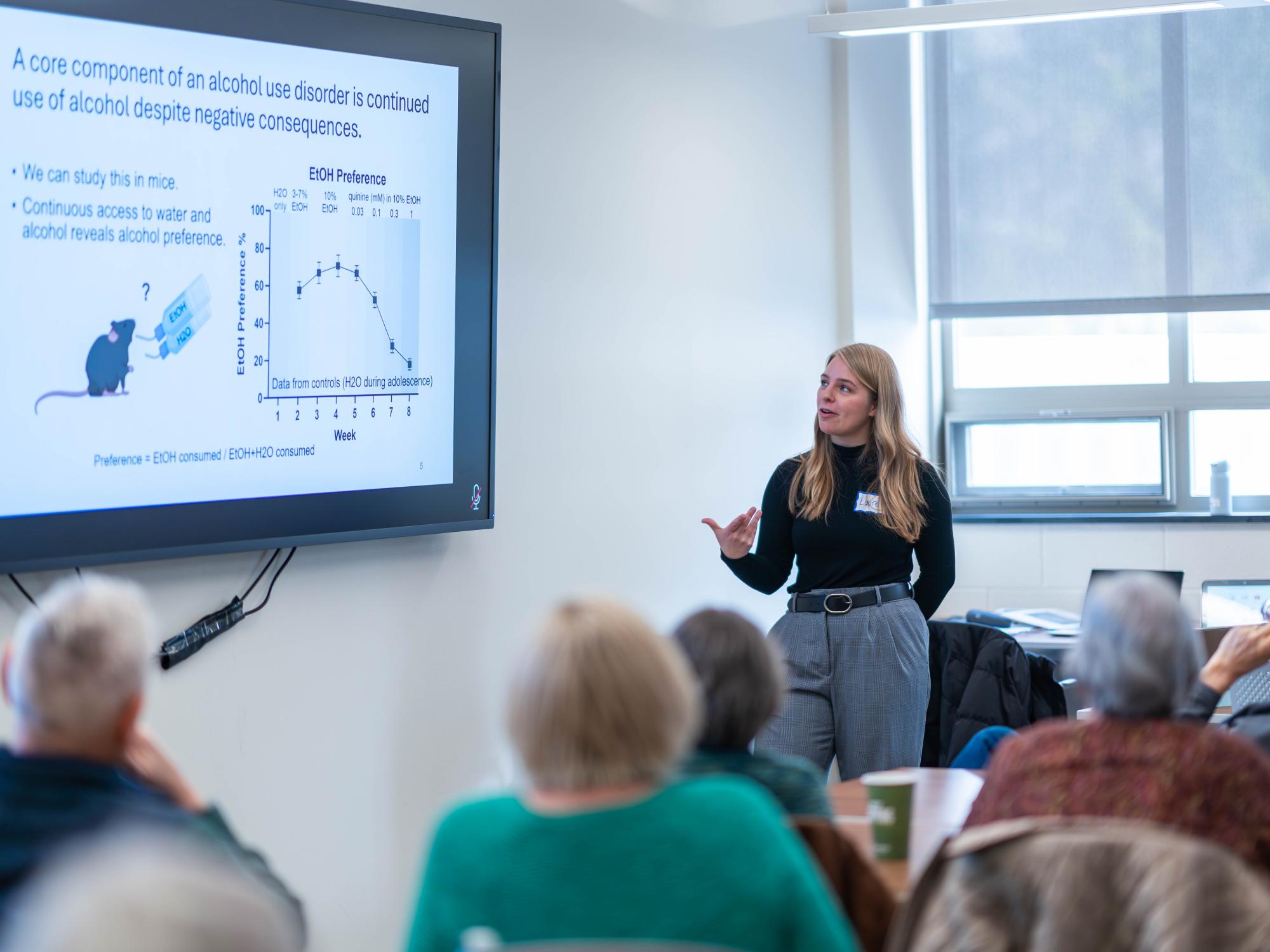 Laurel Seemiller, postdoc in Nikki Crowley's lab, speaks to members of the Village at Penn State. 