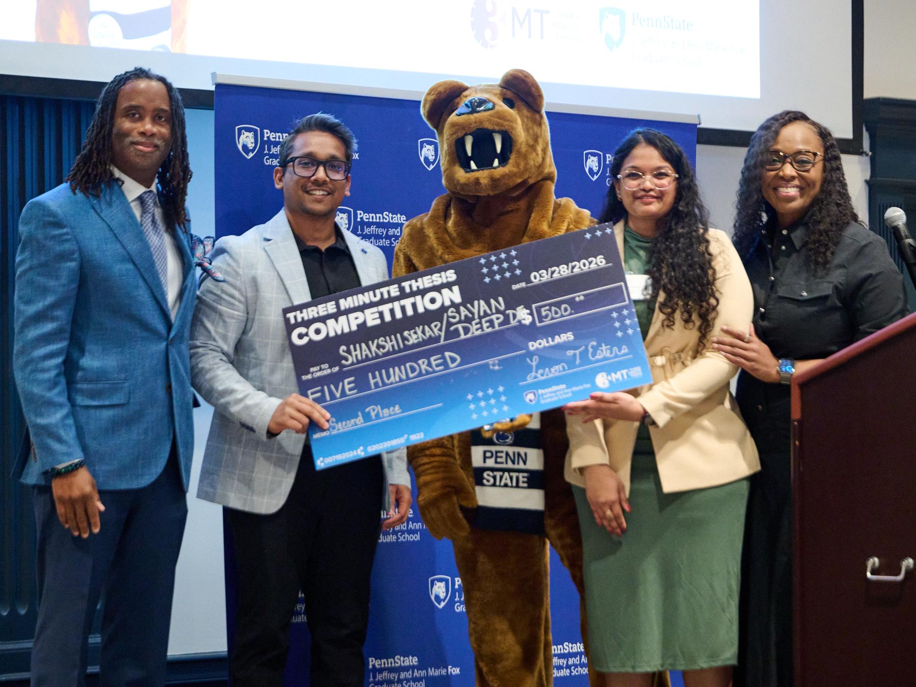 Two 3MT winners pose with the Nittany Lion, Dean Esters and Dean Preston