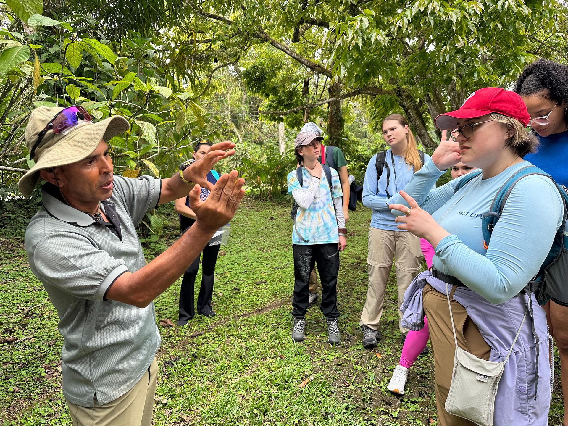 A Costa Rican farmer interacts with U.S. college students
