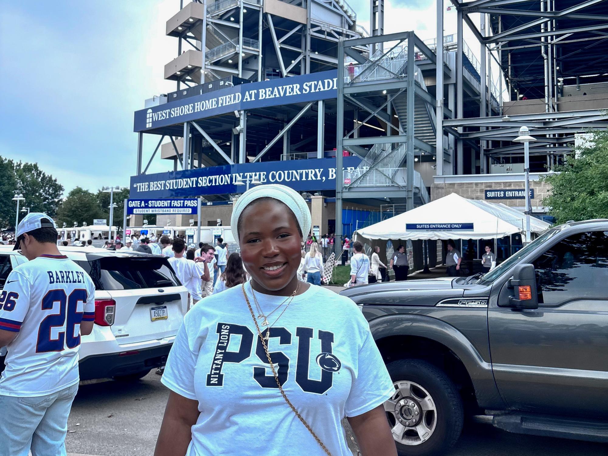 Safiya Haruna wears a white shirt that reads “PSU” while standing outside Beaver Stadium.