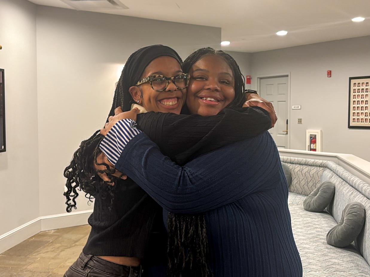 Trinidy Manison and Laci Campbell smile and embrace in a hug. 