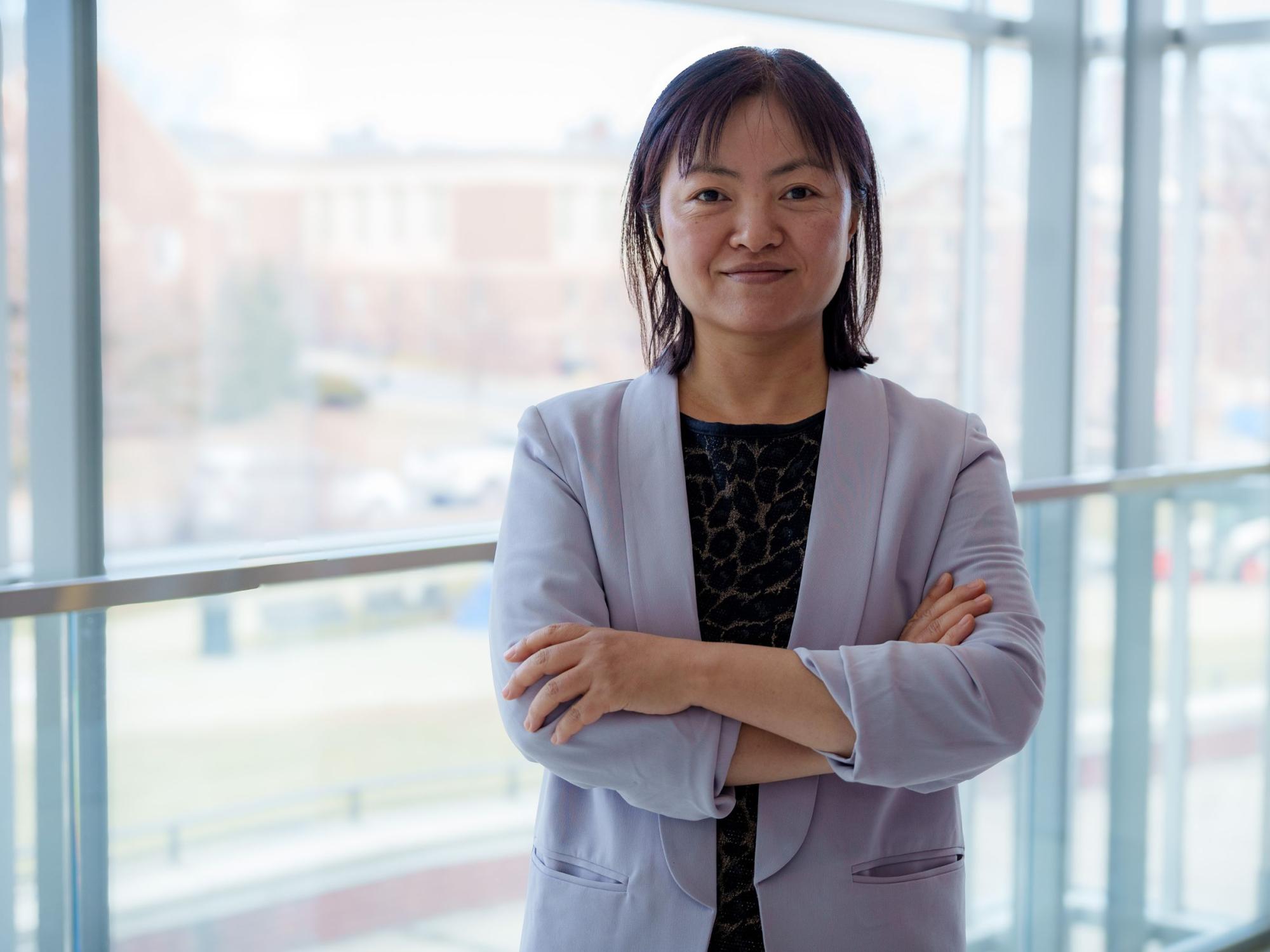 person in business clothes with windows in background