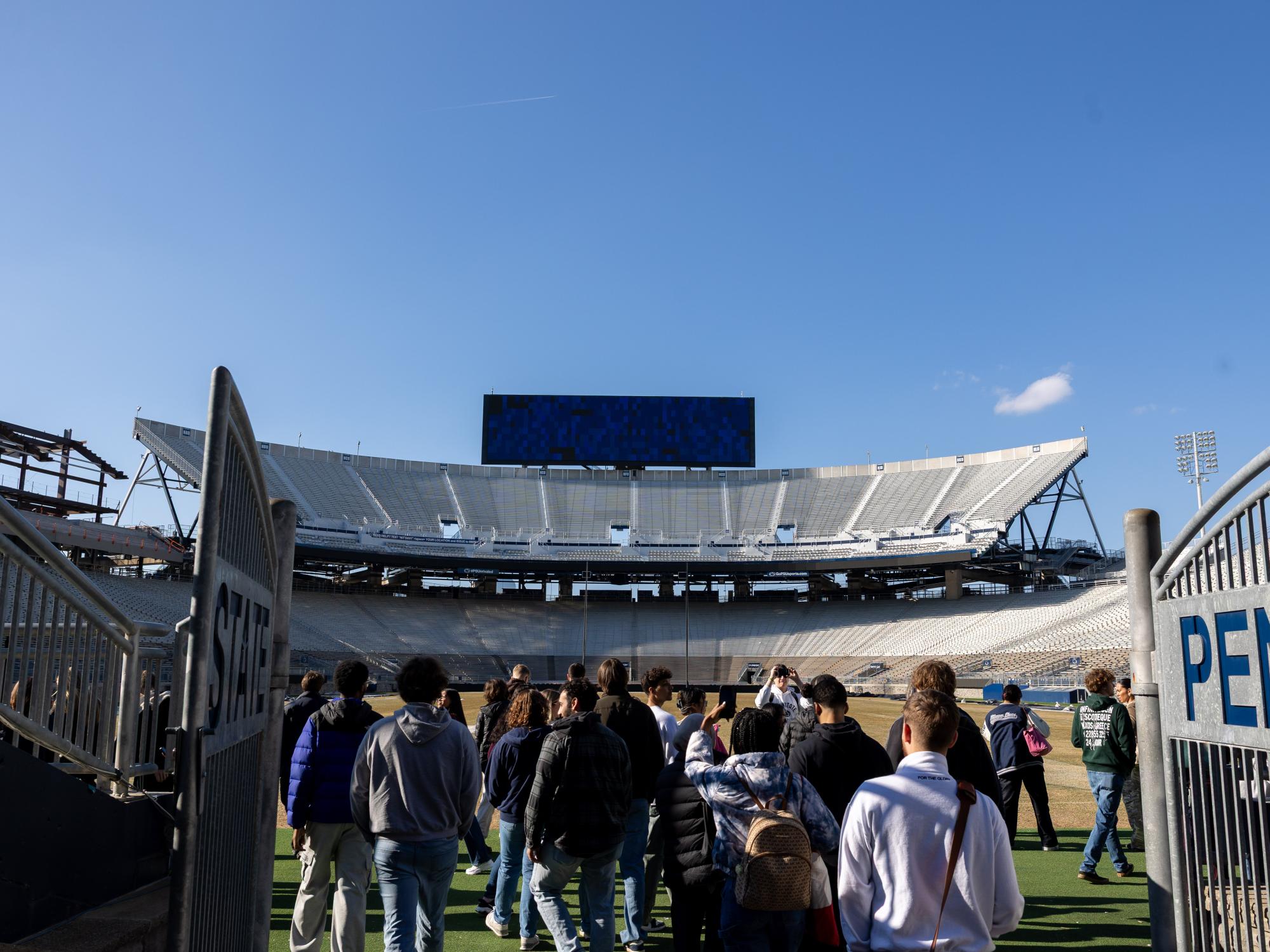 Students walk out onto the field at Beaver Stadium