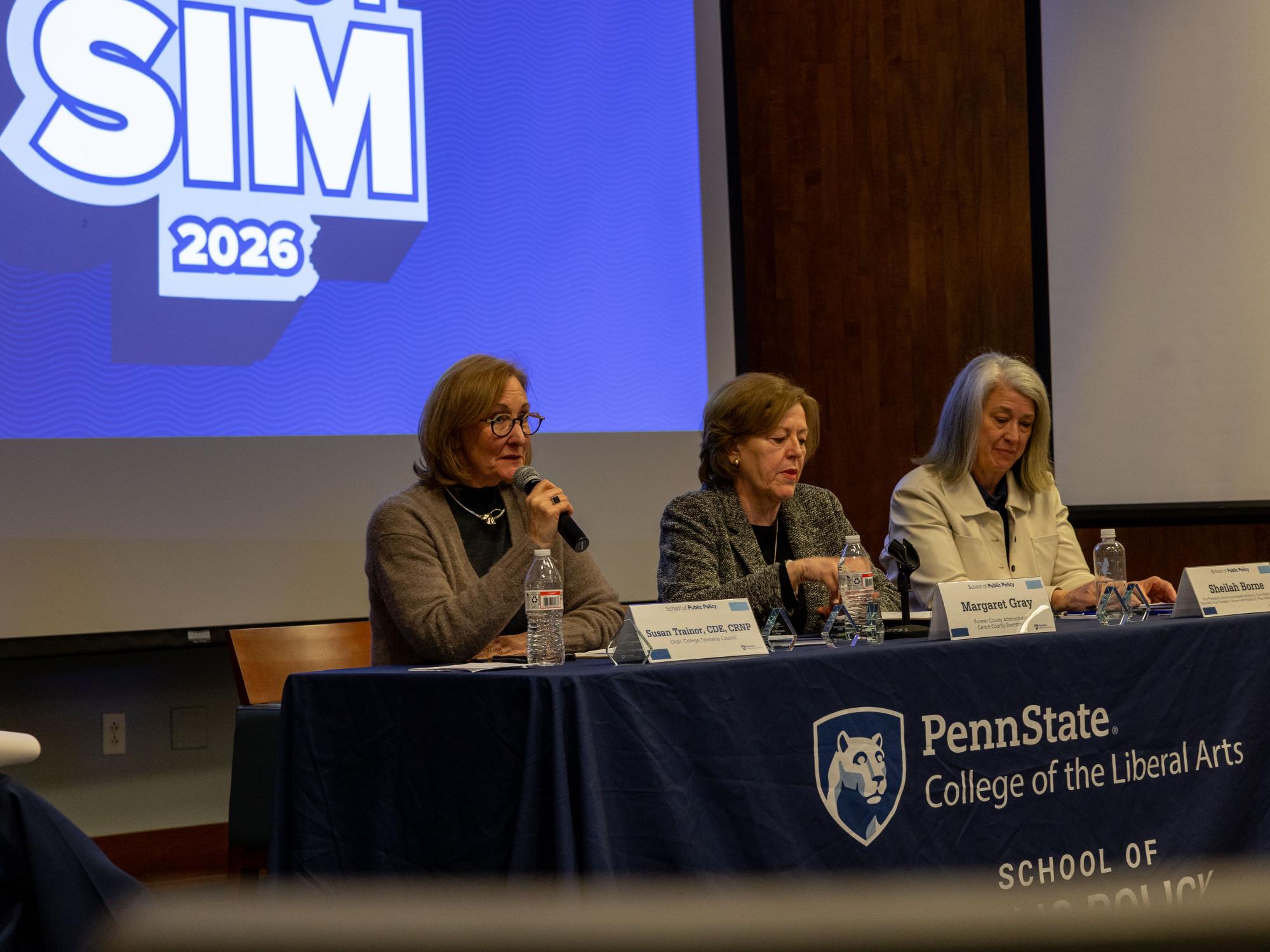Judges Susan Trainor, Margaret Gray, and Sheilah Borne sit at a table with a School of Public Policy tablecloth.