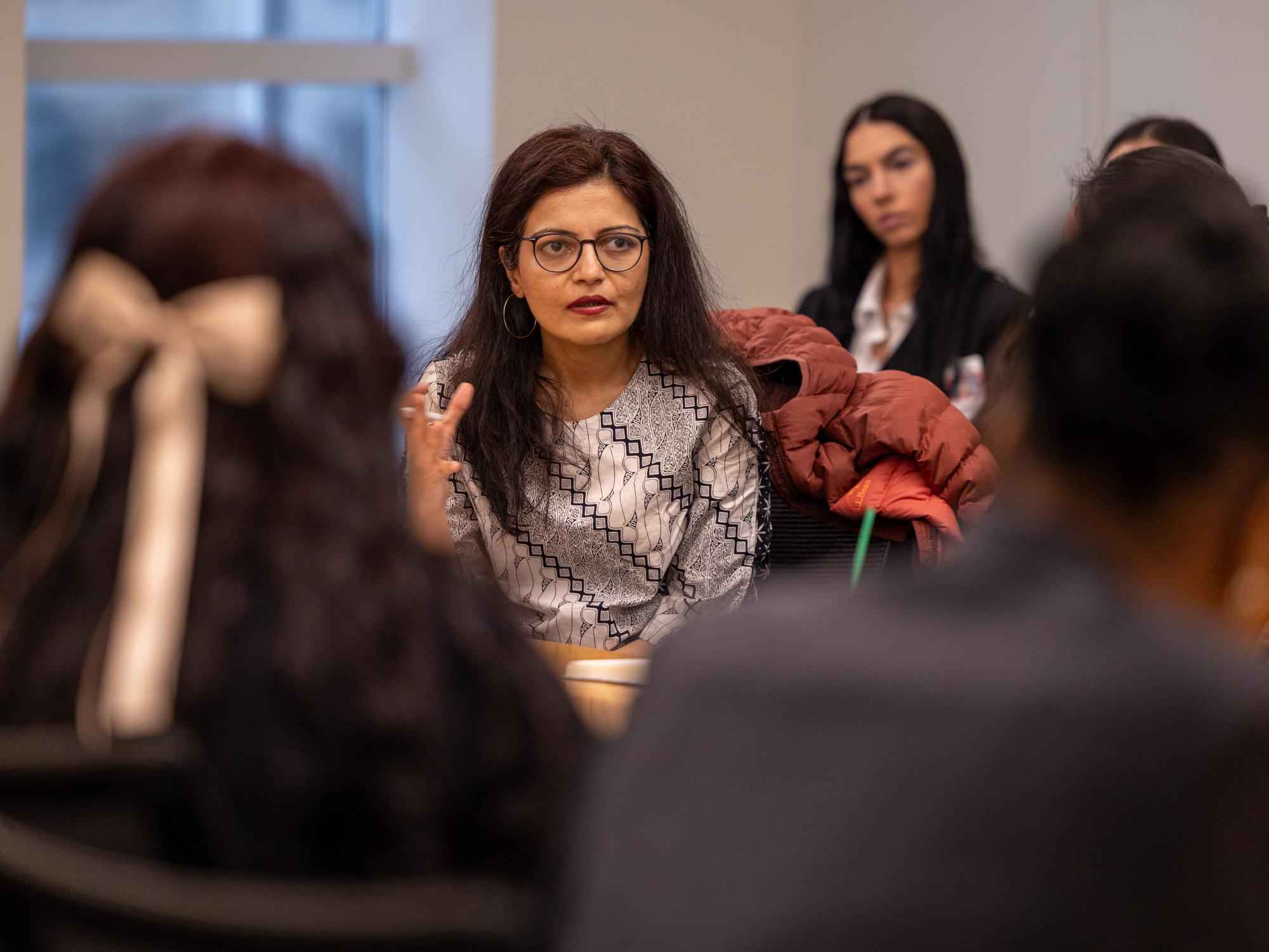 Esha Dilip Zaver speaks with a crowd of students. 