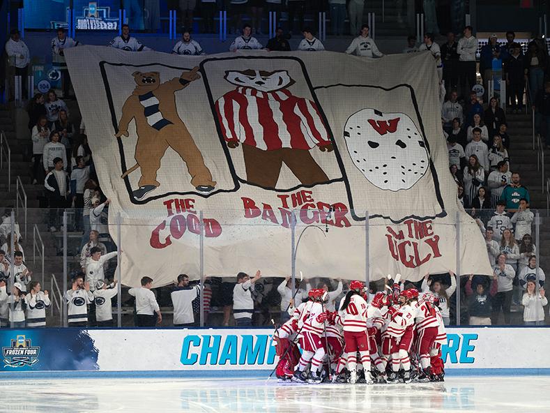 Crowd displays large banner