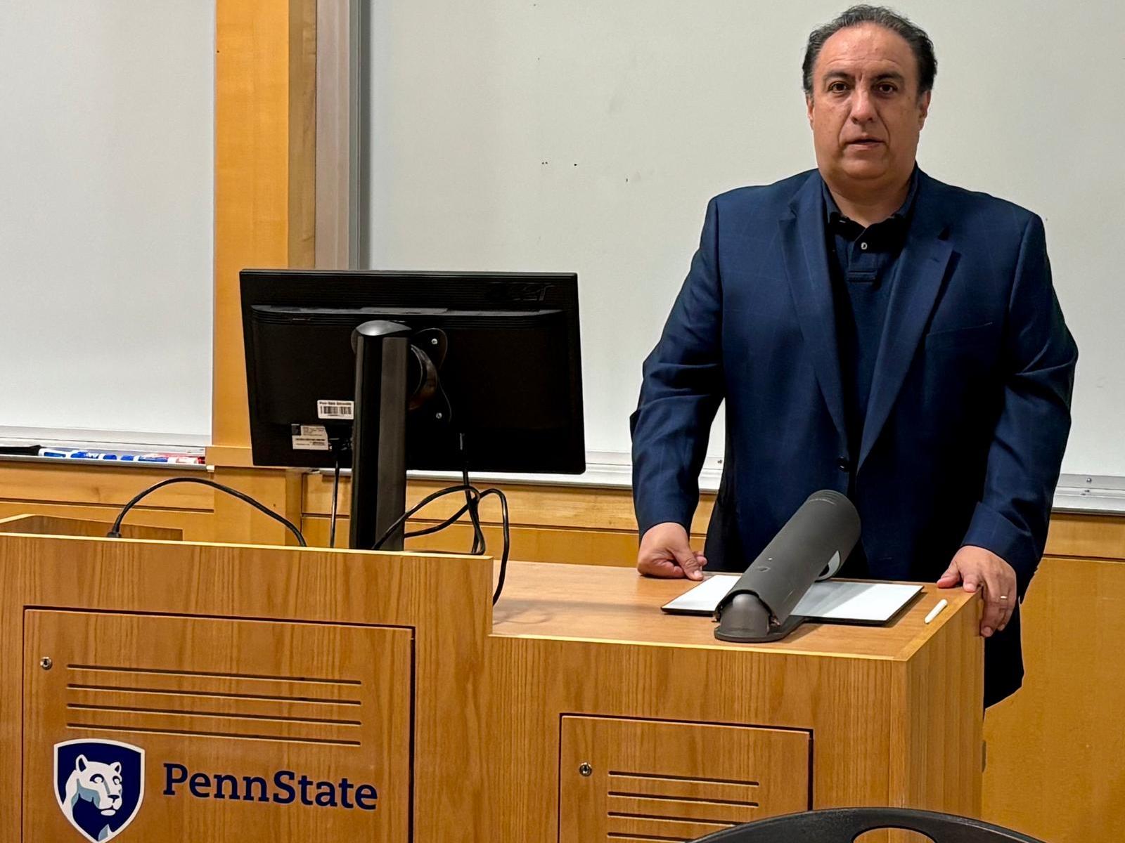 Mauricio Maldonado standing at classroom podium