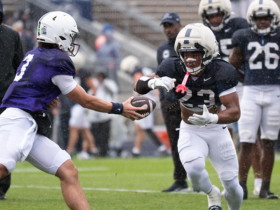 Man hands ball to running back