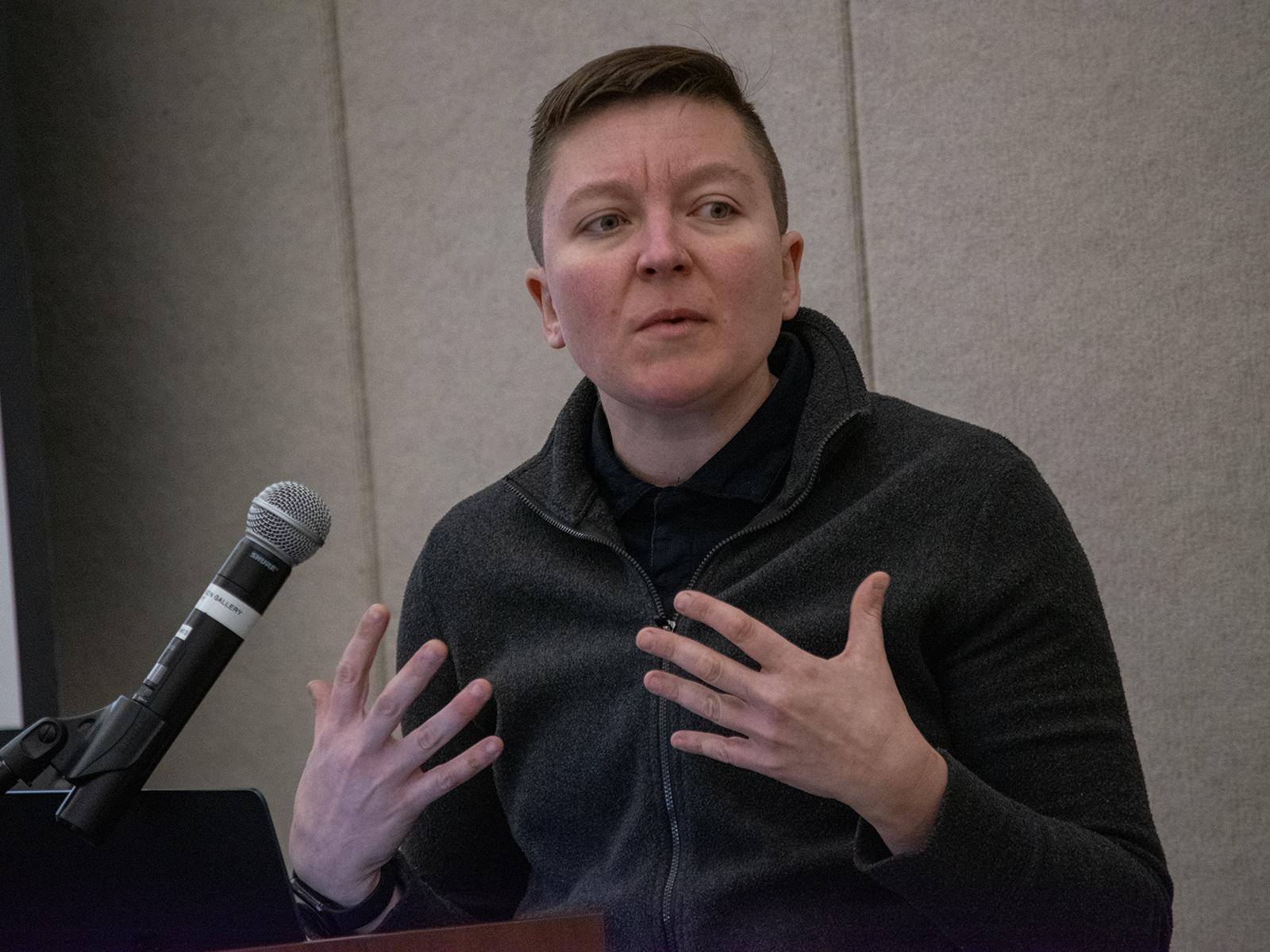 Mary Zaborskis speaks behind a microphone