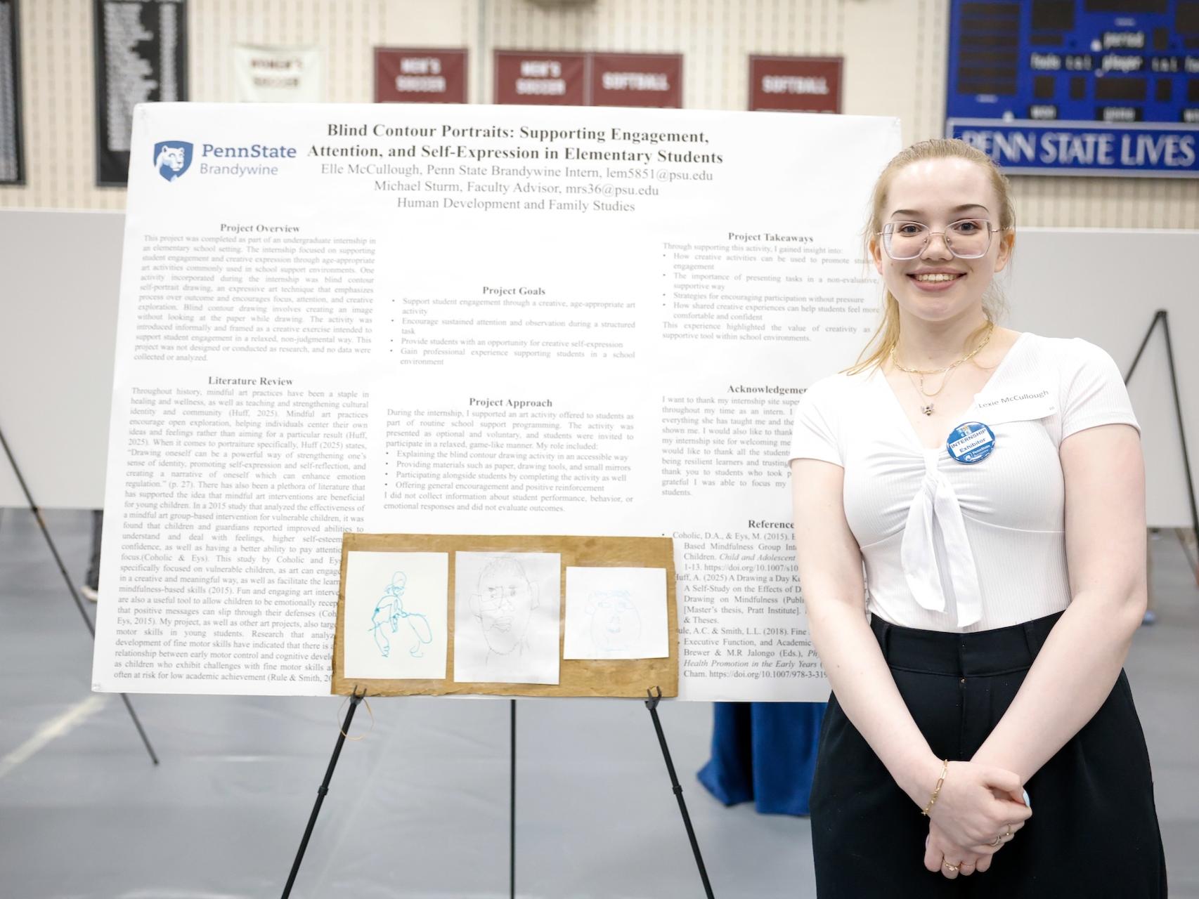 student standing in front of poster about her HDFS internship