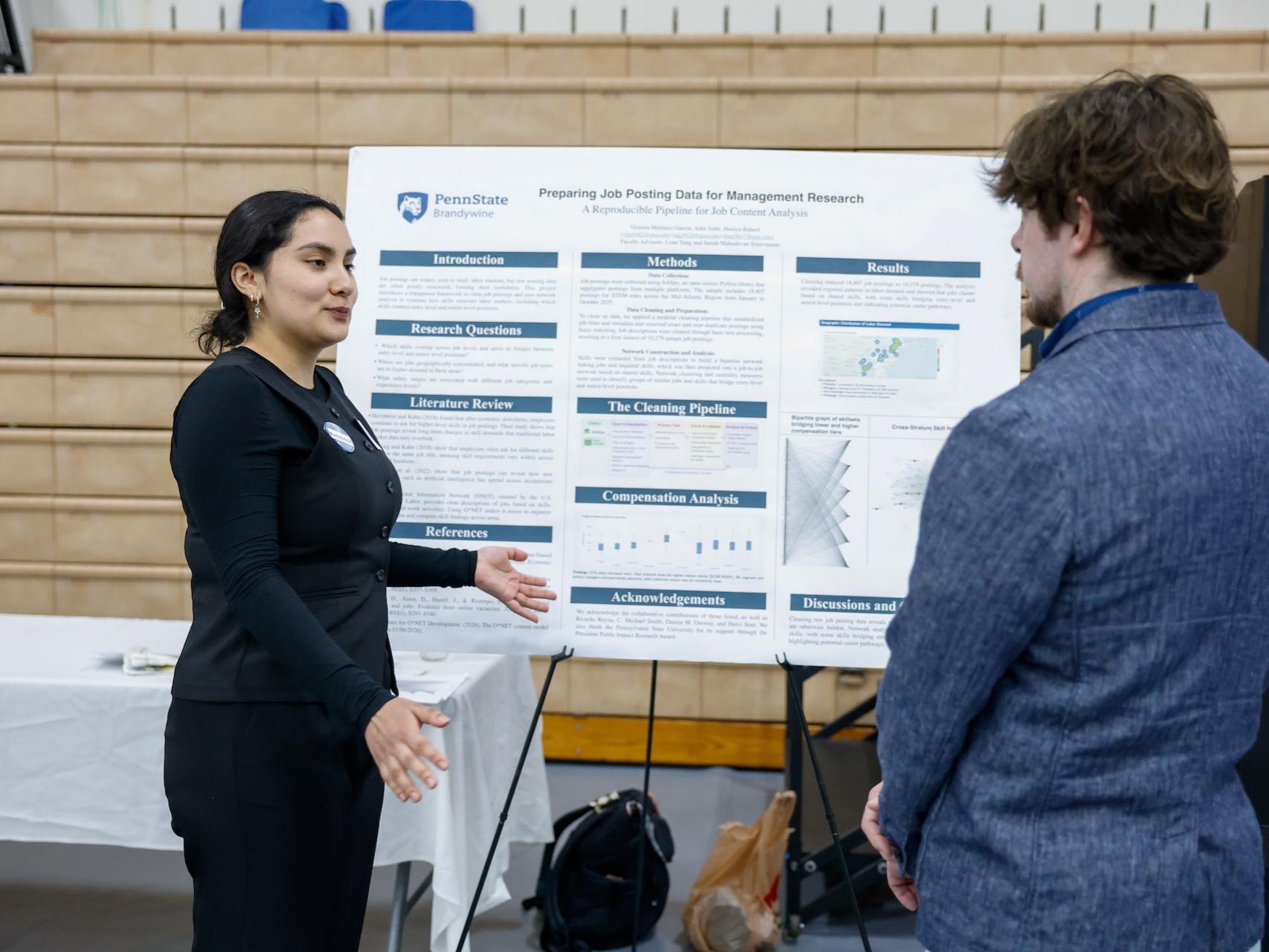 student explaining her research on job posting data to a professor
