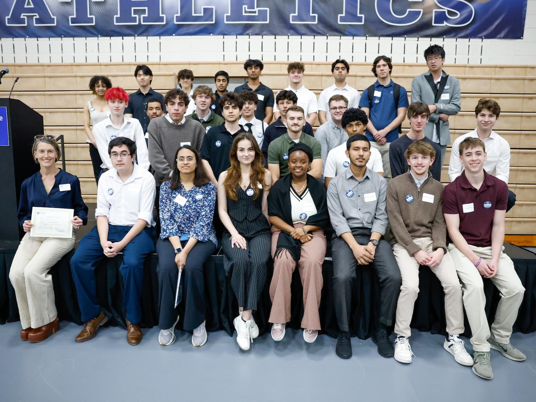 Students in Introduction to Engineering Design on stage posing after they won the Best in Class Award at the Student Engagement Expo.