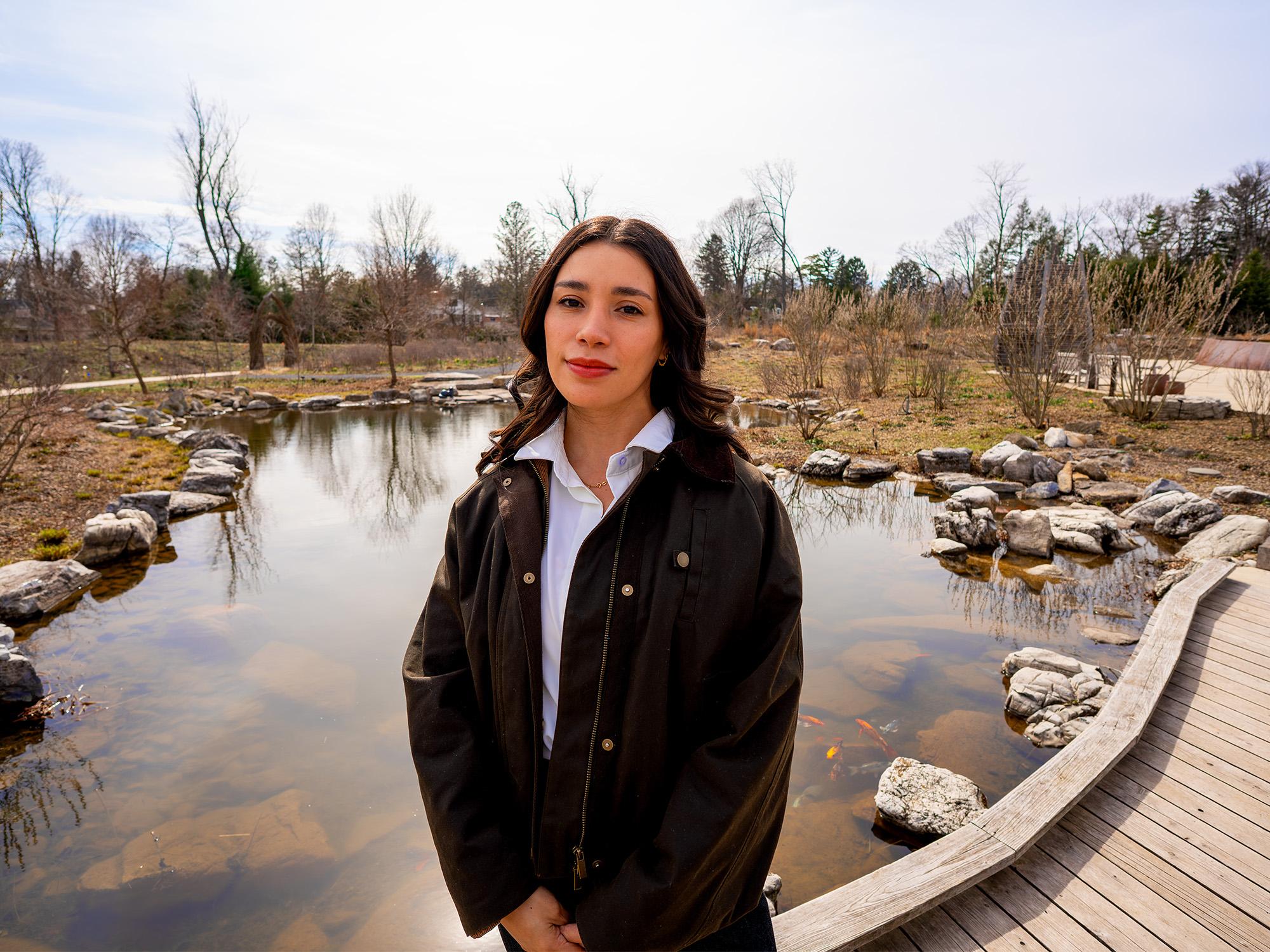 woman standing in front of pond