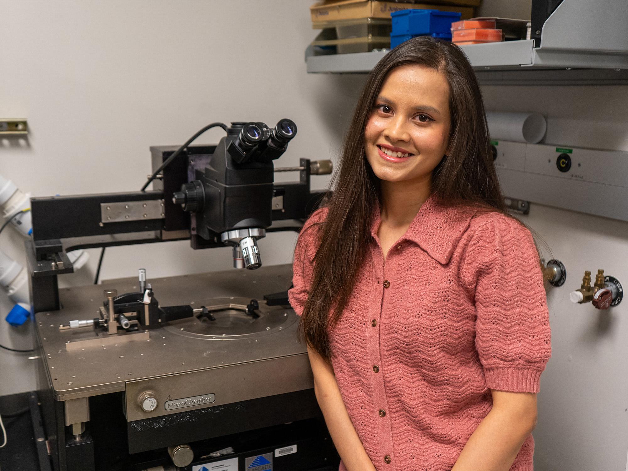woman student next to microscope