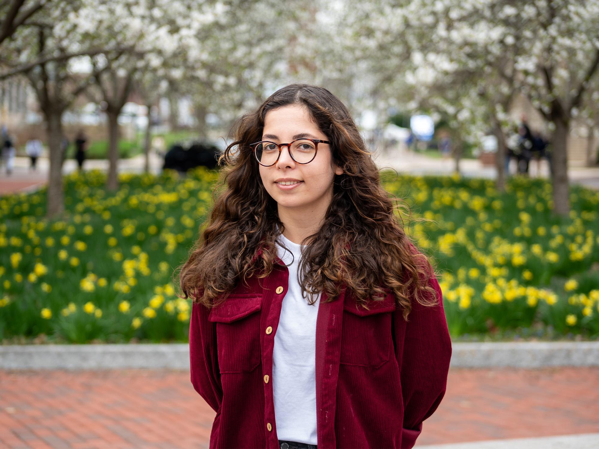 woman in front of daffodils
