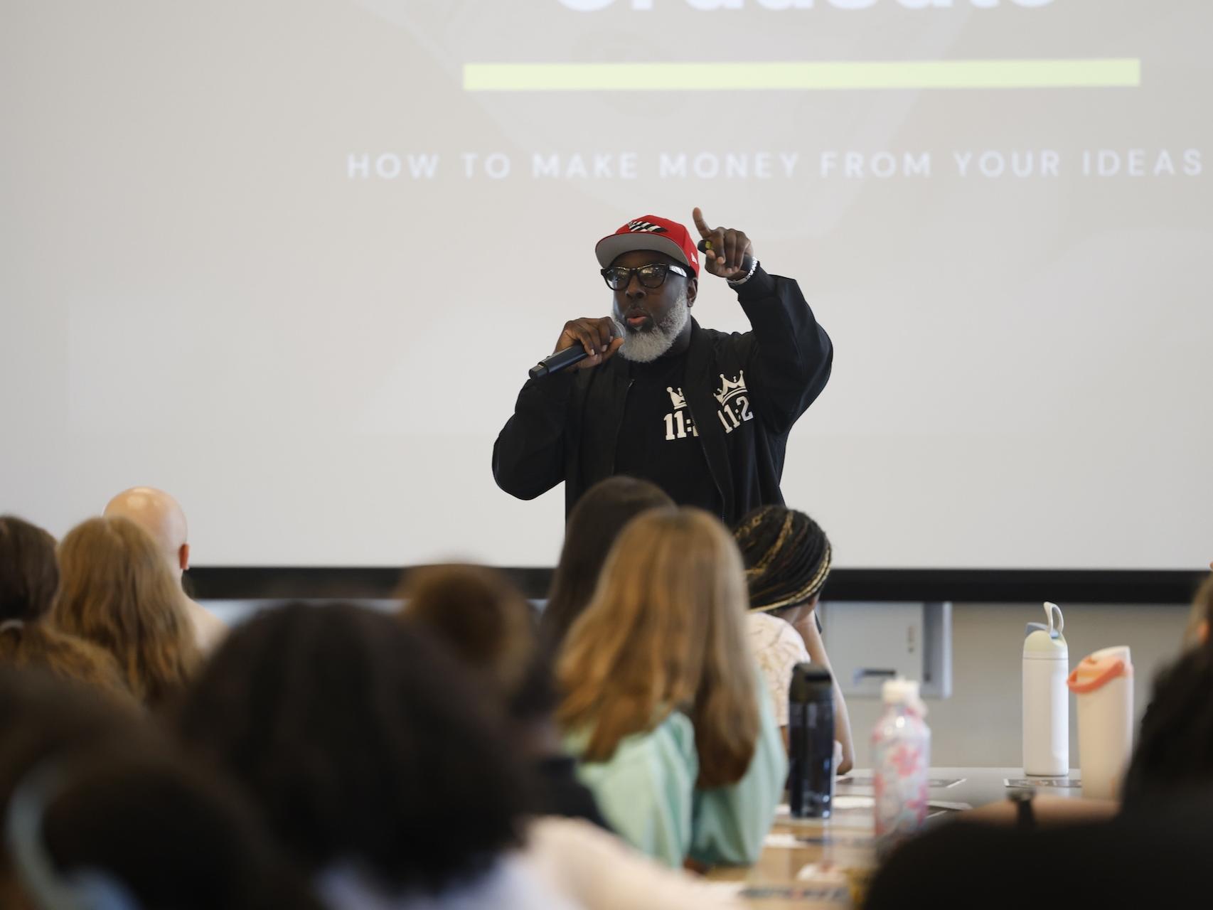 Kevin Sutton speaking in front of crowd of high school students
