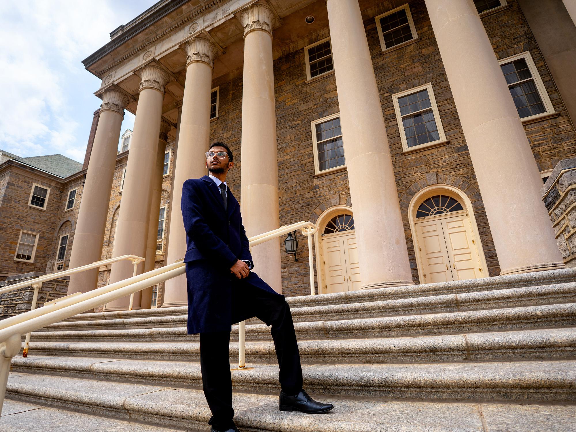 person on stairs in front of building with pillars