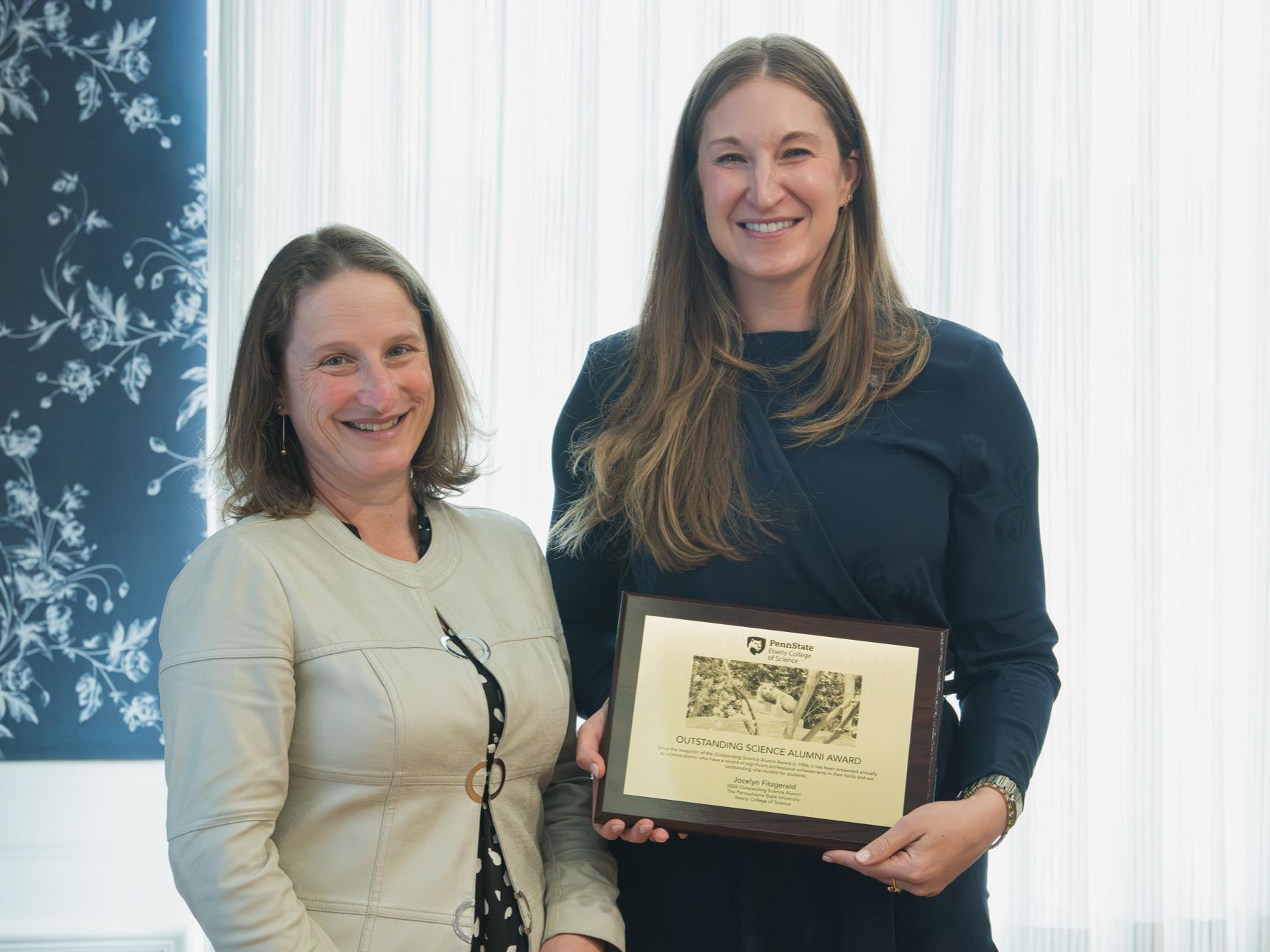 Jocelyn Fitzgerald accepting the Outstanding Science Alumni Award from Penn State Eberly College of Science Dean Tracy Langkilde.