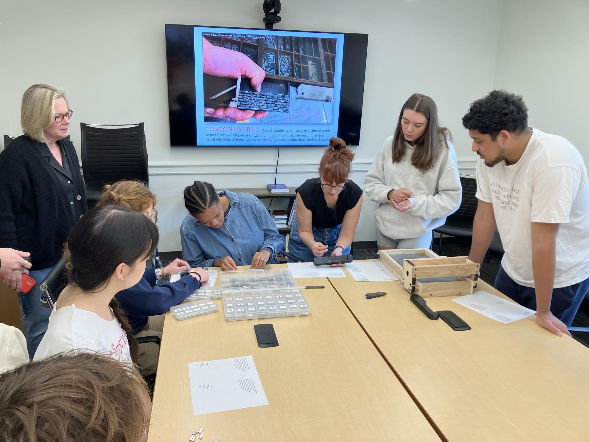 Claire Bourne demonstrates how to set type during a hands-on letterpress workshop