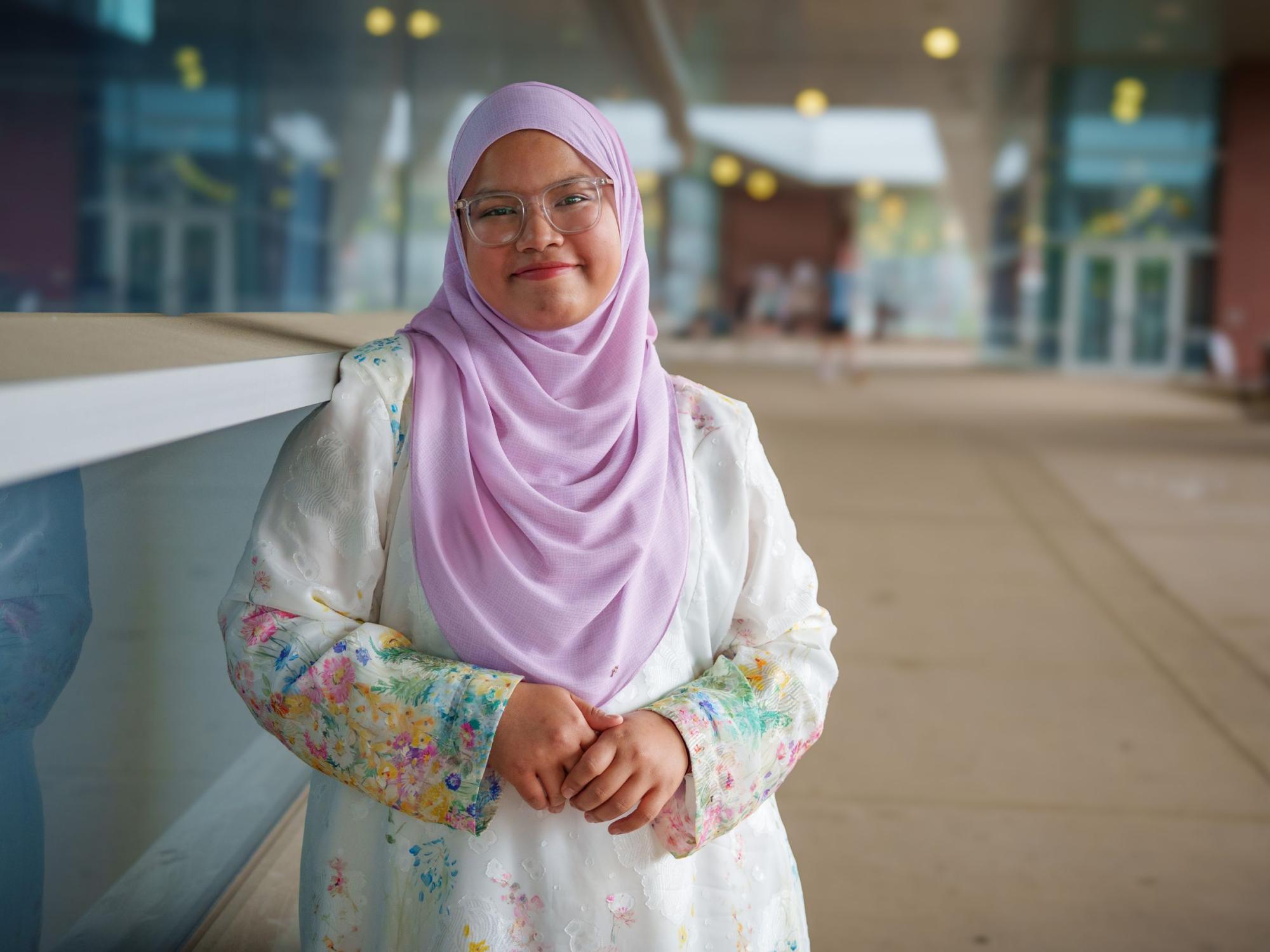 college student wearing glasses and hijab 