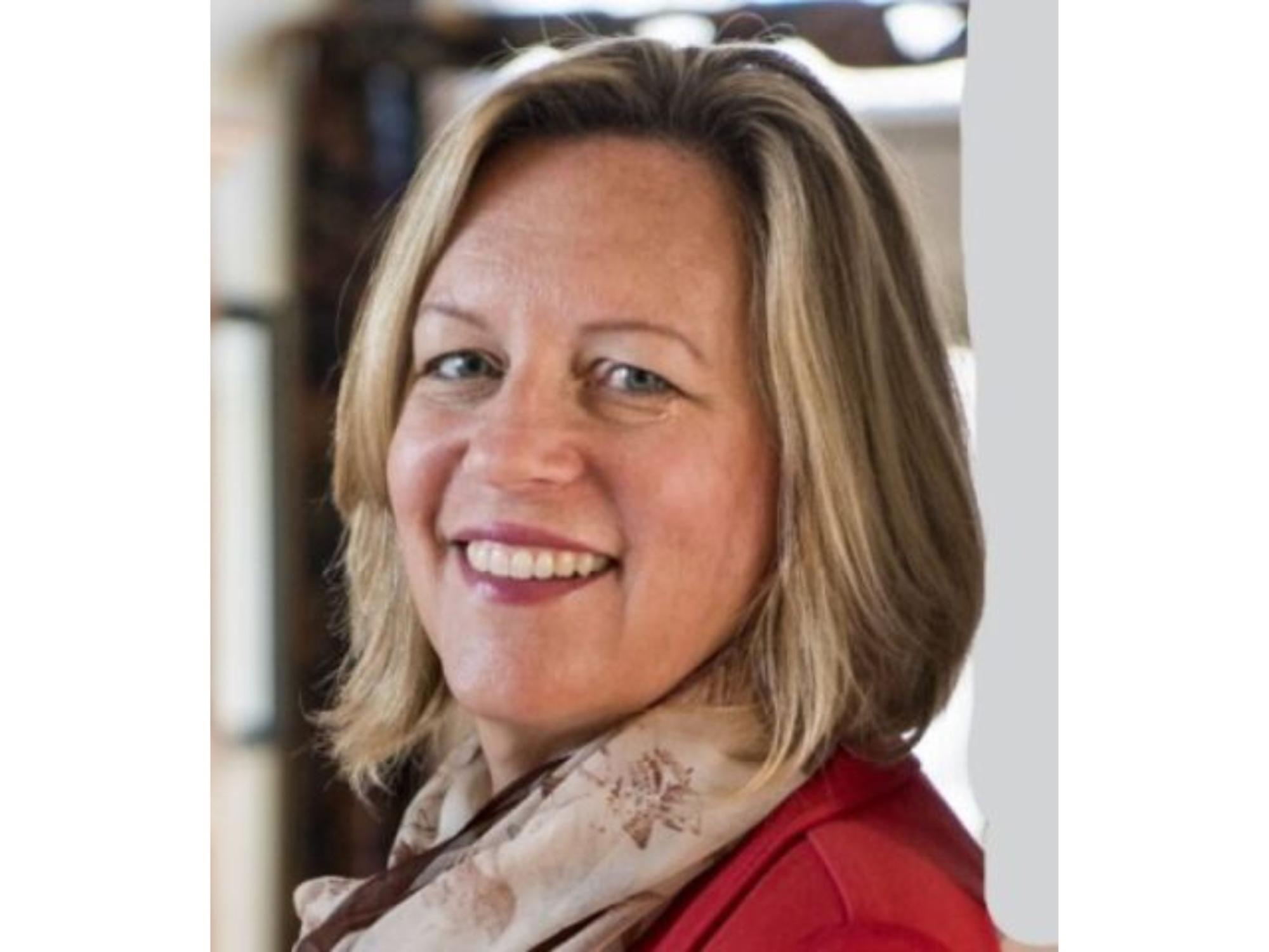 professional headshot of smiling blonde person