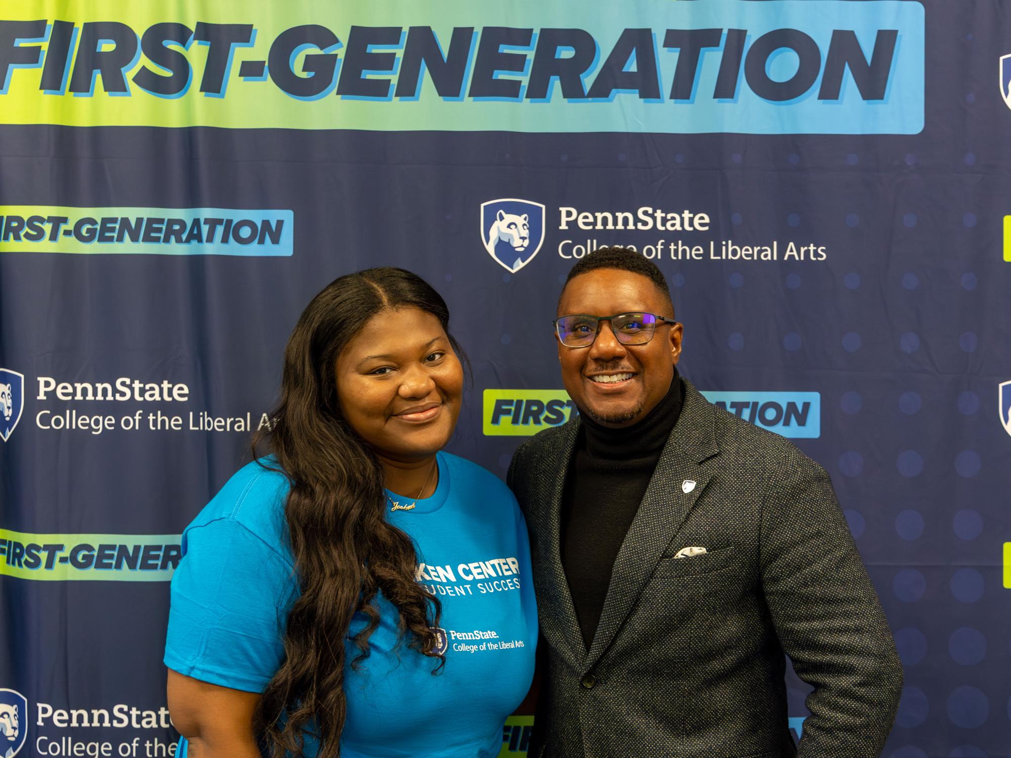 Shaquana Simpson and Clarence Lang stand in front of a navy backdrop that reads, “First-Generation” and “College of the Liberal Arts.”