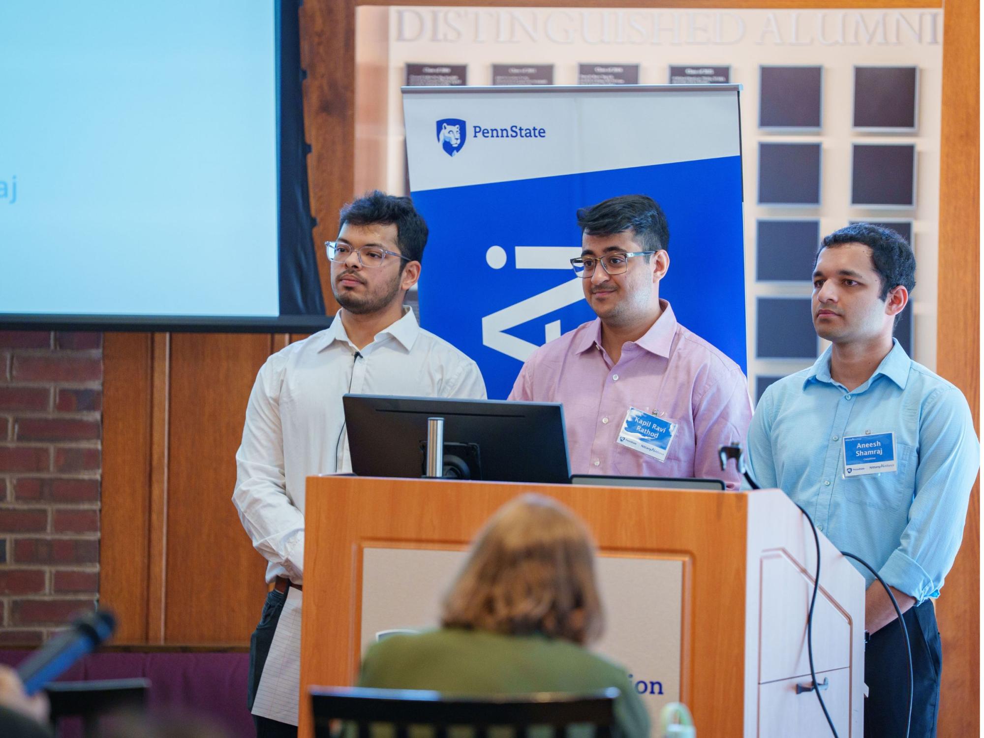 three people standing at a podium