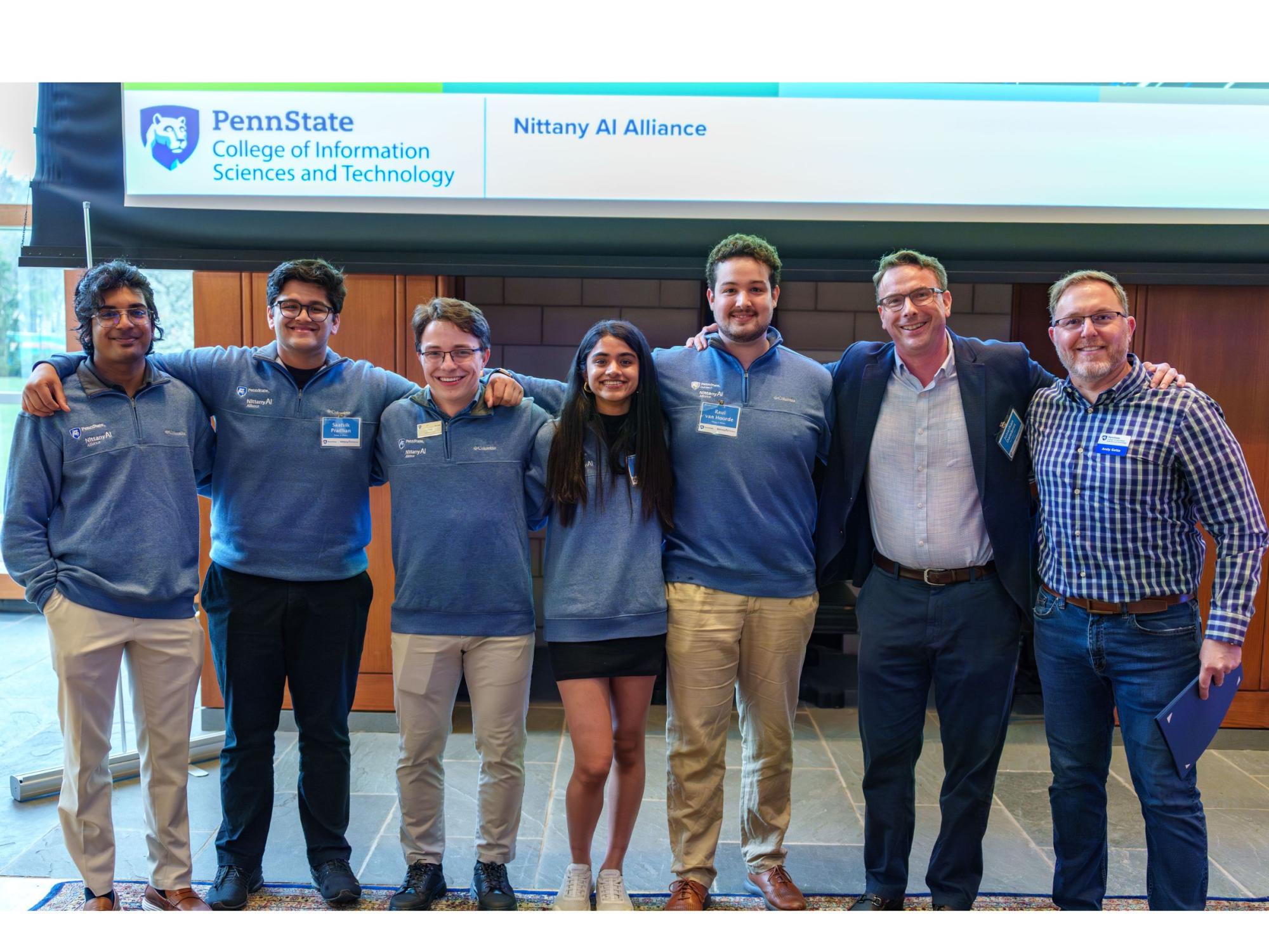 a row of seven smiling college students and adults