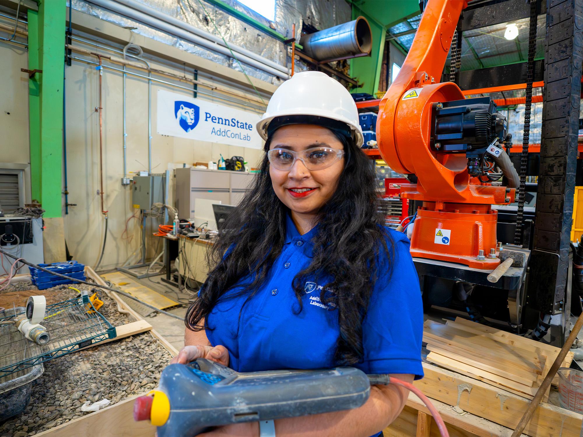 woman holding clipboard in robotics construction lab