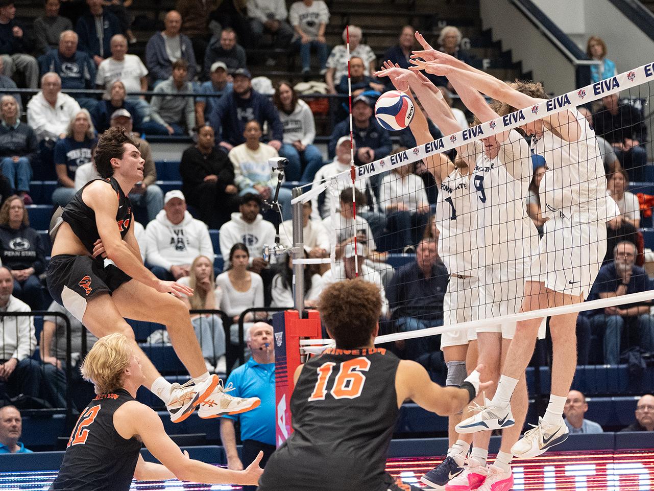 Three players block a player's spike