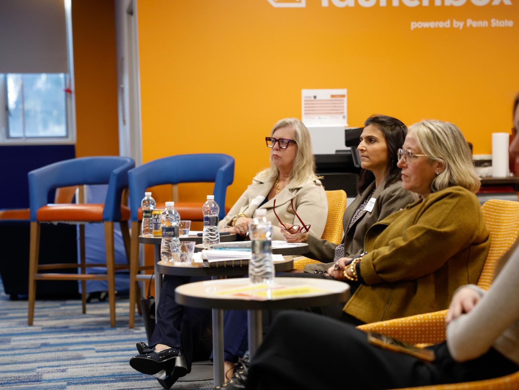 Marcia O'Connor, Panthini Patel and Bonnie Rivera sitting in chairs judging 