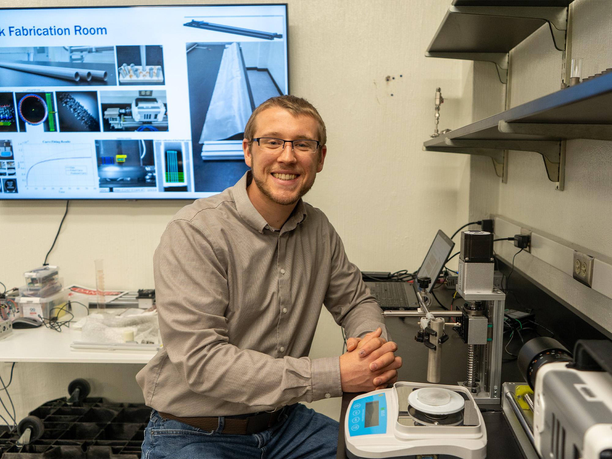 person in lab next to scale
