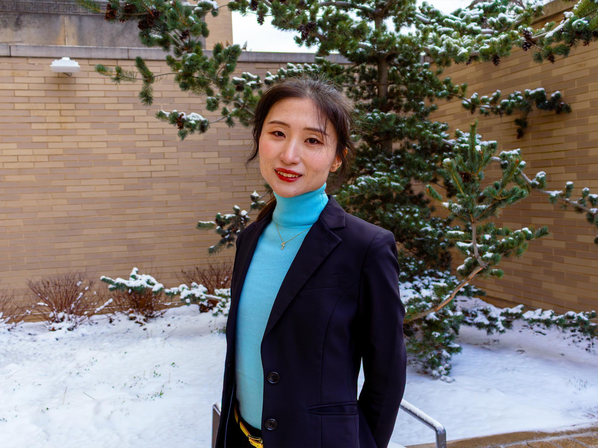 woman with snow and building in background
