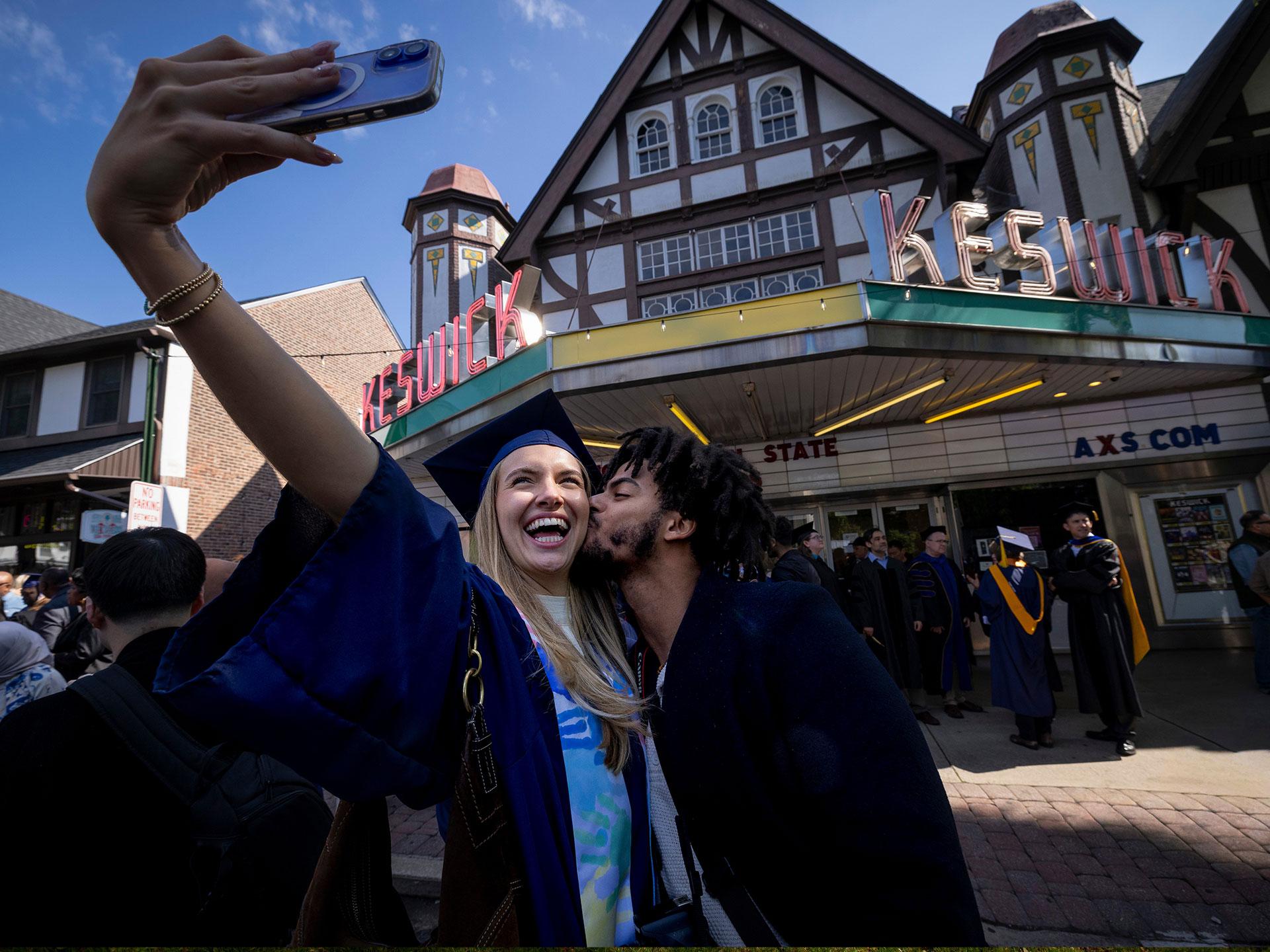 Two new graduates celebrating after commencement