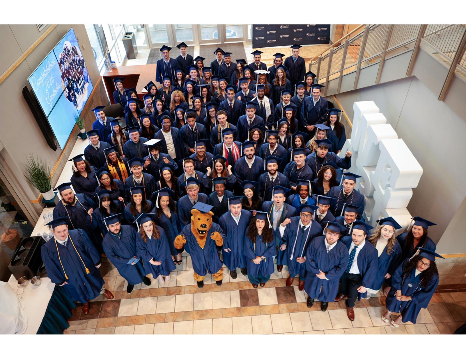 An aerial view of a large group of happy college graduates in their caps and gowns 