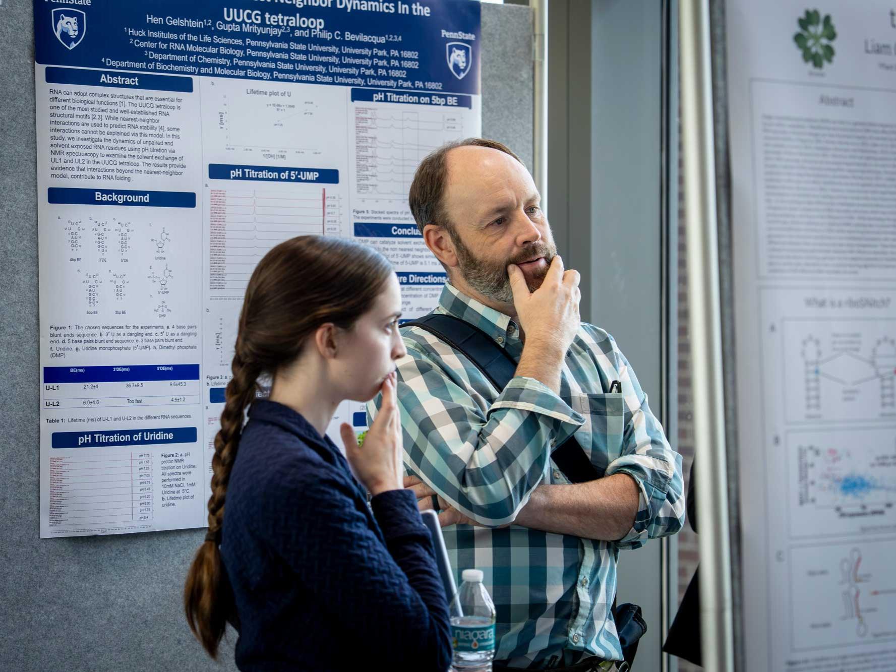 Mike Axtell and student look at research posters