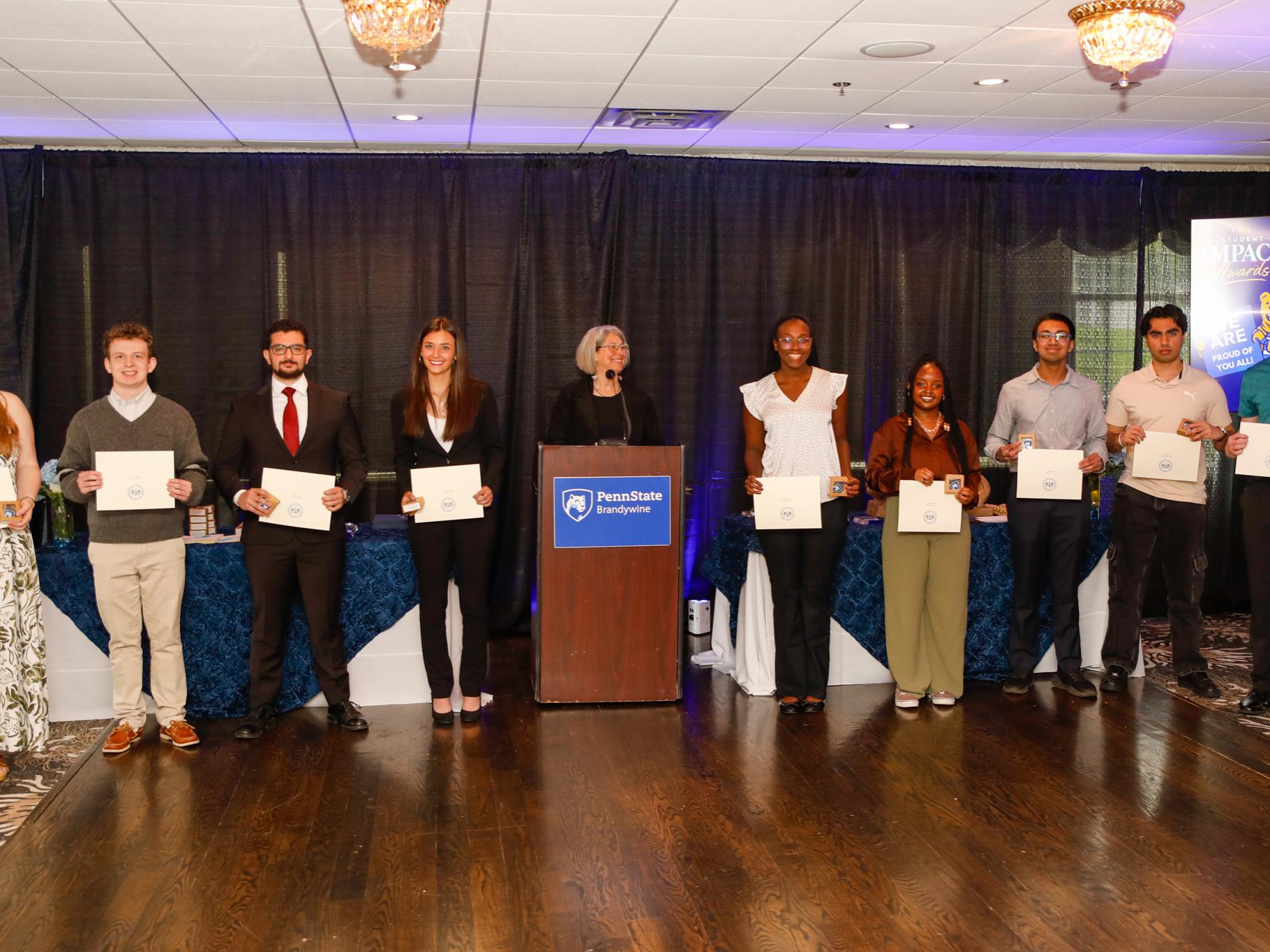 students holding their certificates