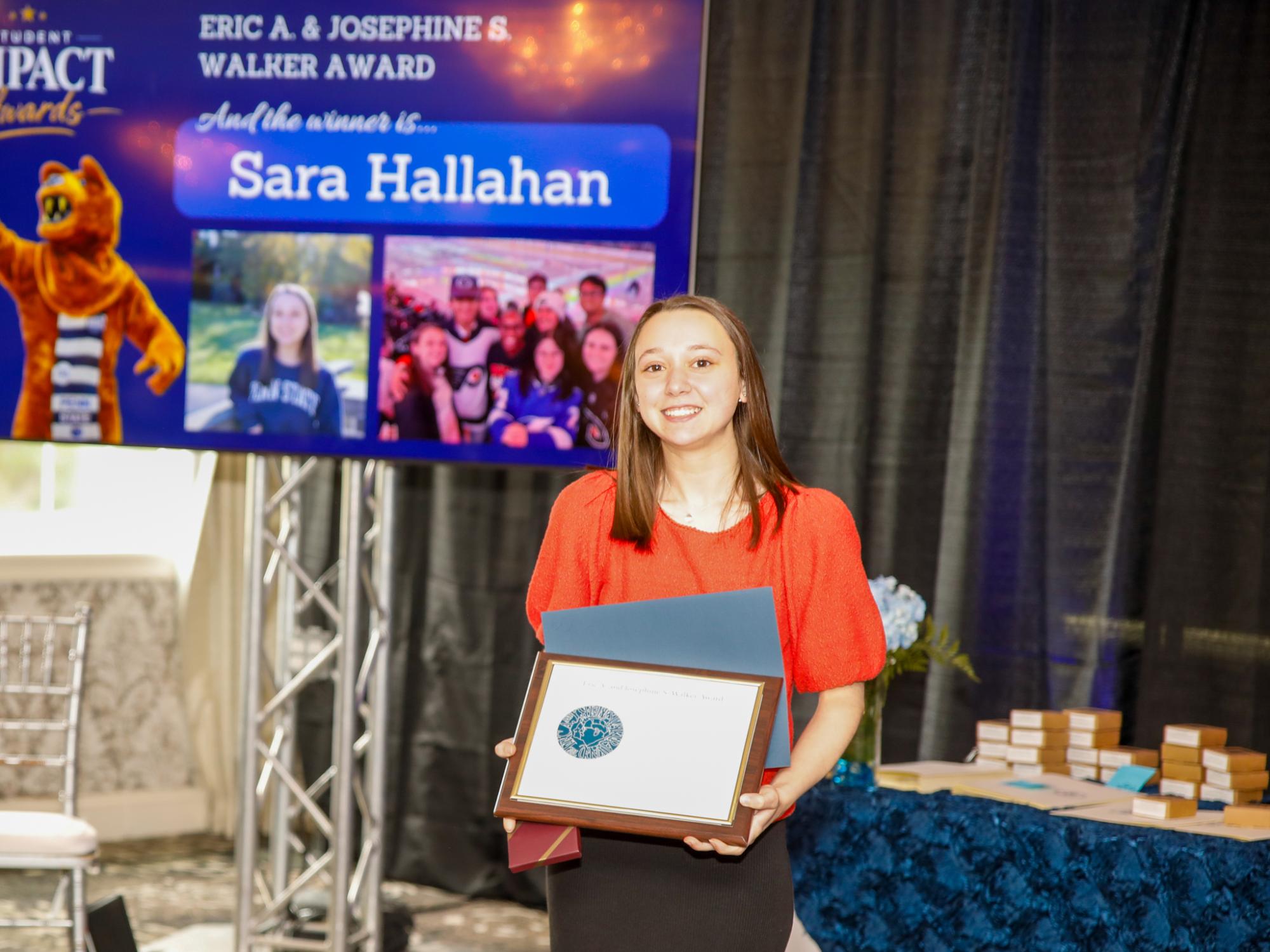 sara hallahan holding her award