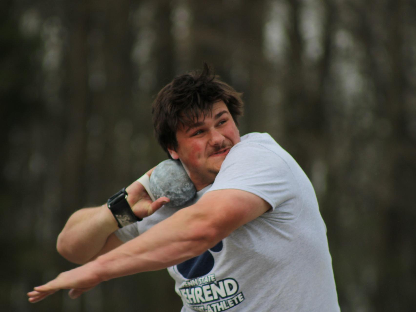 Penn State Behrend student-athlete Alex Cotton throws the shot put.