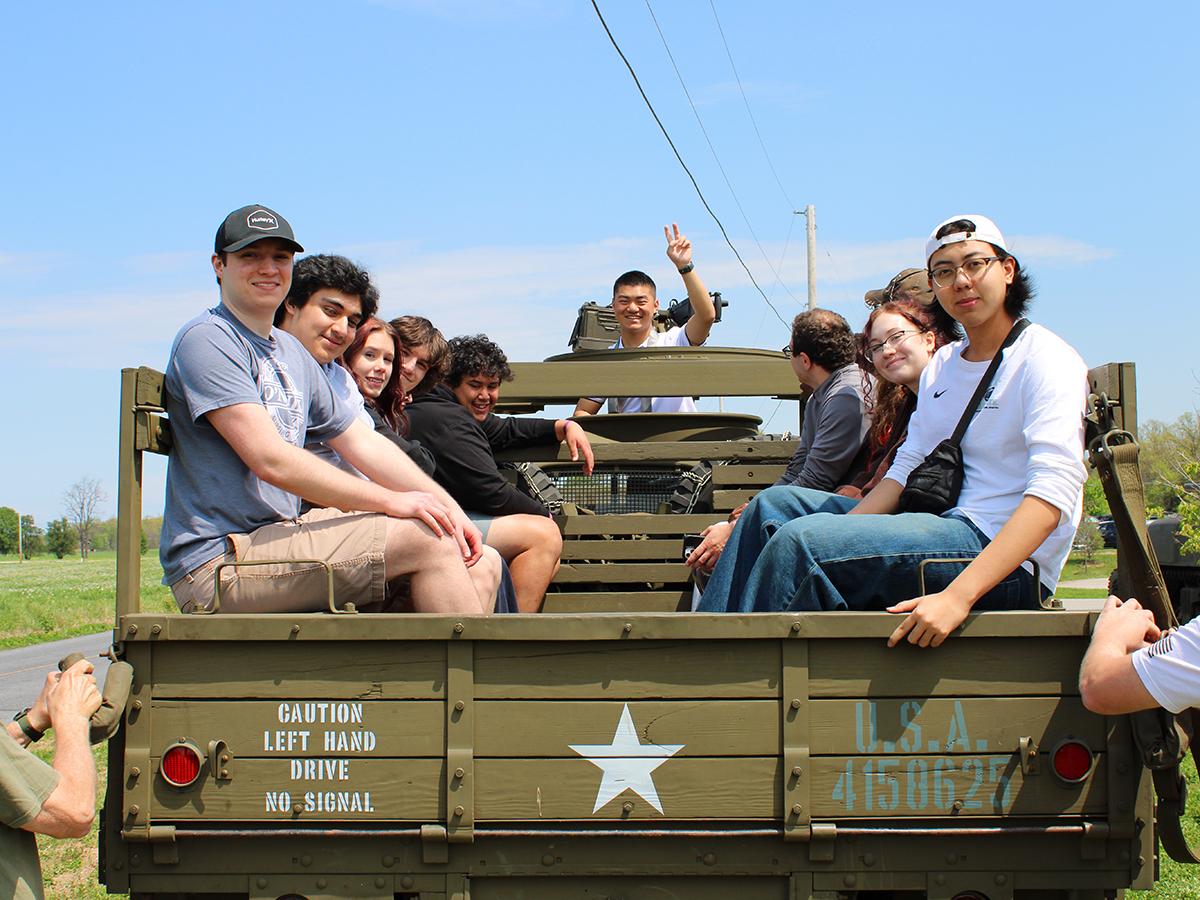 Students ride in a period Army truck during a field trip to Gettysburg.