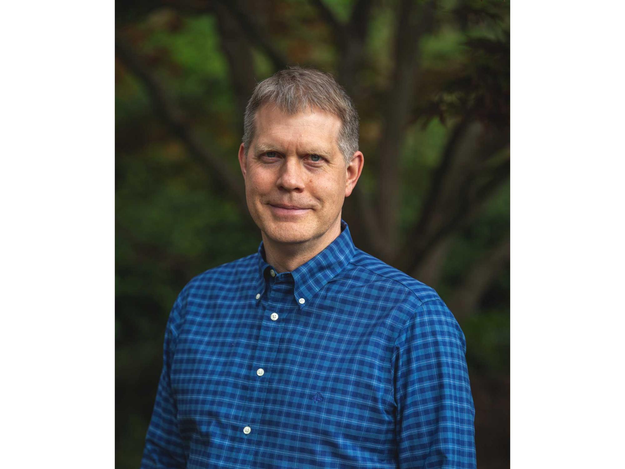 Niel Brandt in front of green trees
