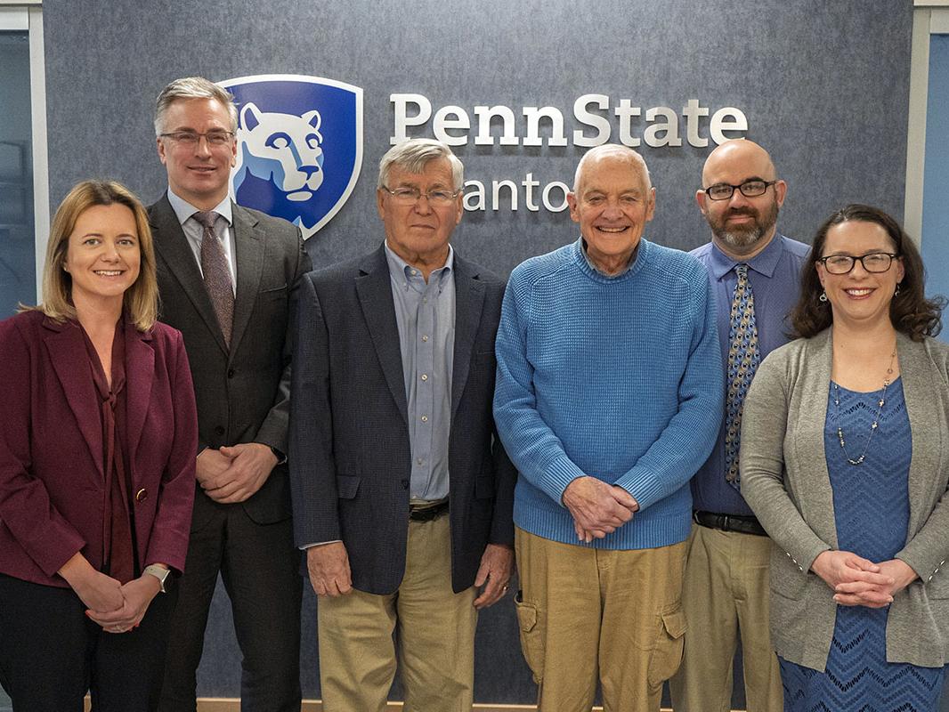 Joe Clifford and Mike Abdalla pose for a shot with Abdalla's family and PSU staff