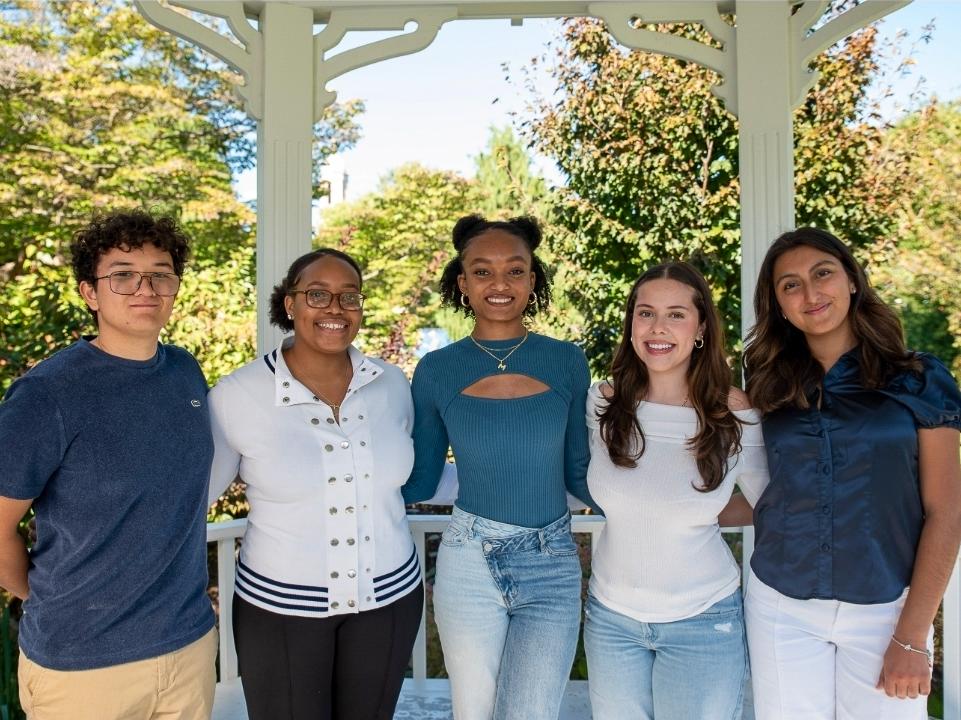 Milan Dukes, center, stands with fellow first-gen advocates at the Hintz Alumni Center.
