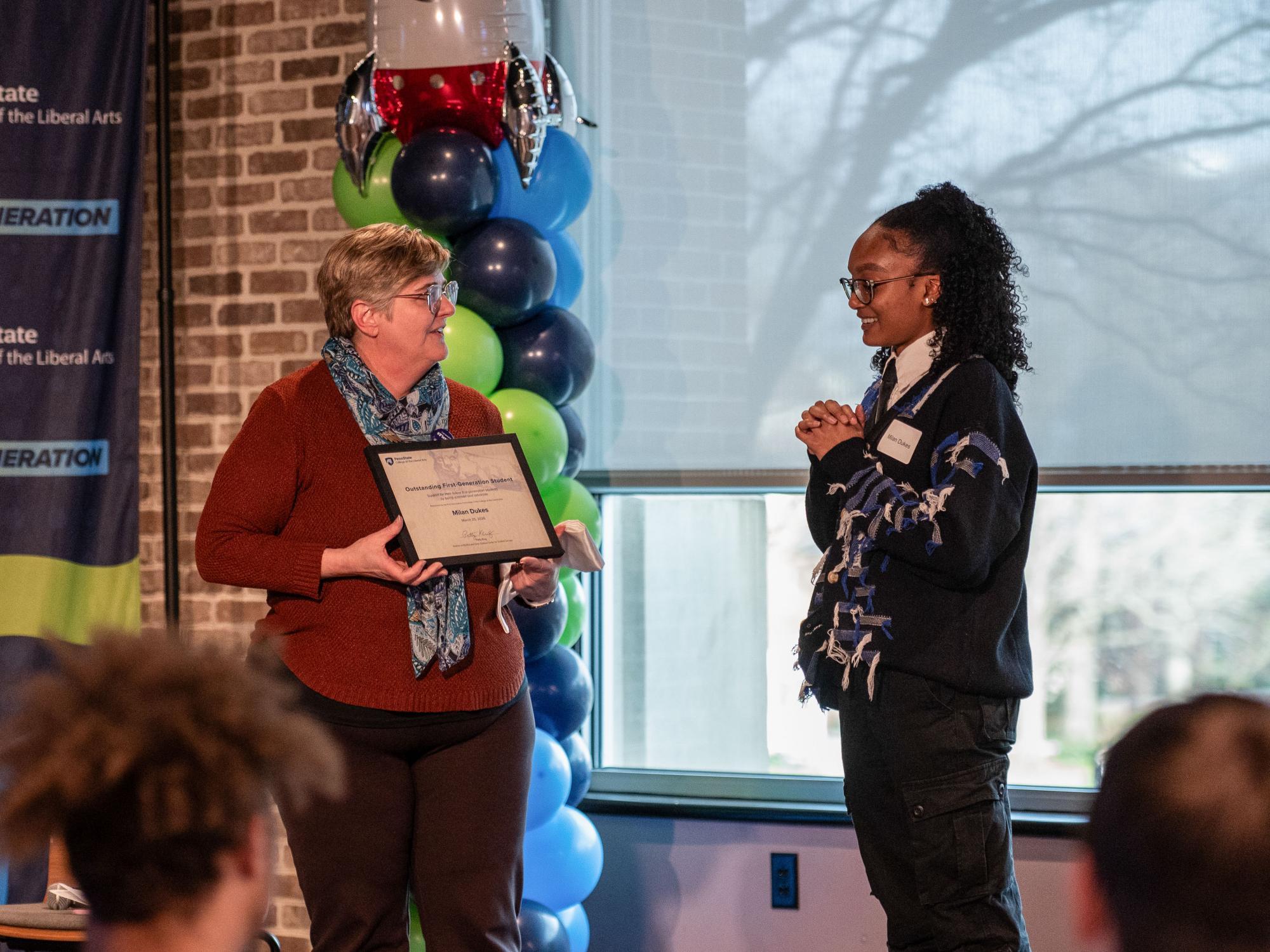 Patty Klug presents the 2026 Liberal Arts Outstanding First-Gen Student Award to Milan Dukes.