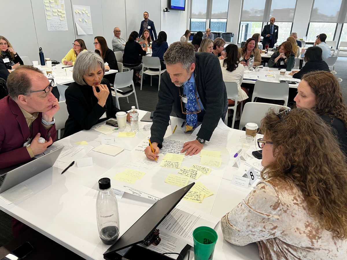 Researchers lead a co-creation roundtable at the symposium.